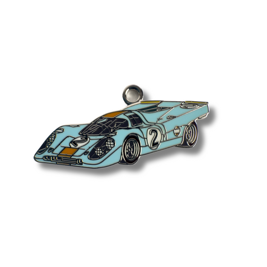 Close-up of RaceDogs Porsche 917K ID Tag featuring enamel finish and iconic car-inspired design.
